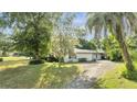 Side view of a ranch home with driveway at 715 Eastover Cir, Deland, FL 32724