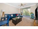 Living room with sectional sofa, balcony access, and TV at 12837 Madison Pointe Cir # 206, Orlando, FL 32821