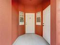 Front entryway with white door and coral walls at 8472 Crystal Cove Loop, Kissimmee, FL 34747