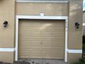 Tan two-car garage with beige doors and white trim at 10791 Gran Paradiso Dr # S, Orlando, FL 32832