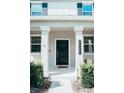 Modern home exterior with black front door at 15031 Book Club Rd, Winter Garden, FL 34787