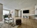 Bright living room with tile floors and dining area at 2210 Grand Cayman Ct # 1722, Kissimmee, FL 34741