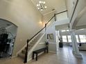 Two-story foyer with a staircase, tile floors, and high ceilings at 2321 Hinsdale Dr, Kissimmee, FL 34741