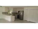 Kitchen with white cabinets and stainless steel appliances at 106 Sparrow Ct, Kissimmee, FL 34759