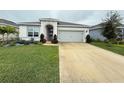 House exterior with well-manicured lawn at 5652 Arborvista Dr, Saint Cloud, FL 34771