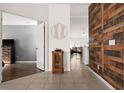 Bright entryway with wood-look accent wall, and view of living area at 2090 Big Buck Dr, St Cloud, FL 34772