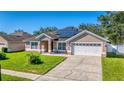 House exterior with solar panels and driveway at 2090 Big Buck Dr, St Cloud, FL 34772