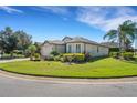 Single-story house with manicured lawn and lush landscaping, situated on a corner lot at 433 Del Sol Ave, Davenport, FL 33837