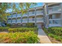 Exterior of a multi-story building with balconies and landscaping at 14036 Fairway Island Dr # 1515, Orlando, FL 32837