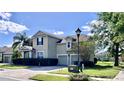 Two story house with a two car garage and manicured lawn at 3040 Palermo Rose Way, Kissimmee, FL 34746