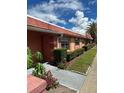 Condo building exterior with landscaping and palm trees at 2727 W Oak Ridge Rd # 3, Orlando, FL 32809