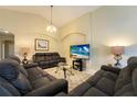 Relaxing living room, featuring comfortable sofas and a large TV at 523 Balmoral Dr, Davenport, FL 33896