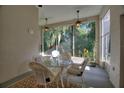 Bright sunroom with wicker furniture and views of the backyard at 520 Vista Oaks Way, Davenport, FL 33837