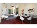 Open concept living and dining area with hardwood floors and modern furniture at 520 Vista Oaks Way, Davenport, FL 33837