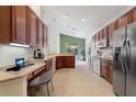 Spacious kitchen with wood cabinets, stainless steel appliances, and an island at 520 Vista Oaks Way, Davenport, FL 33837