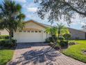 House exterior with a brick driveway and landscaping at 657 Vineyard Way, Kissimmee, FL 34759
