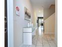 Bright entryway with tile floor and modern console table at 4845 Romeo Cir, Kissimmee, FL 34746