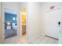 Hallway with tile floors, and views into bedroom and bathroom at 4845 Romeo Cir, Kissimmee, FL 34746