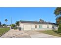 Single-story home with gray and white exterior and attached garage at 35 N Lakeshore Dr, Lake Wales, FL 33859