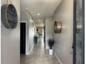 Bright and spacious entryway with tile flooring and modern wall decor at 12254 Sandy Apple Rd, Orlando, FL 32824