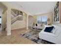 Open living room with a staircase, white couches, and tile floors at 1542 Sun Meadow Dr, Orlando, FL 32824