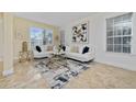 Bright living room with white couches, a large abstract art piece, and tile floors at 1542 Sun Meadow Dr, Orlando, FL 32824