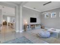 Bright playroom with built-in shelving, comfortable seating, and a view into the living area at 13010 Stoddart Ave, Orlando, FL 32827