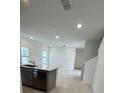 Modern kitchen with island, stainless steel appliances, and ample counter space at 2893 Fitness St, Clermont, FL 34714