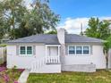 Charming house with gray roof, white walls and landscaping at 117 W Maple St, Davenport, FL 33837