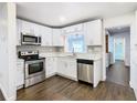 Modern kitchen with white cabinets and stainless steel appliances at 117 W Maple St, Davenport, FL 33837