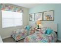 Bedroom with two twin beds and colorful bedding at 4839 Kings Castle Cir, Kissimmee, FL 34746