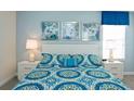 Bedroom with a queen bed and teal bedding at 4839 Kings Castle Cir, Kissimmee, FL 34746