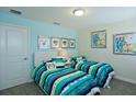 Bright bedroom with two twin beds and colorful bedding at 4839 Kings Castle Cir, Kissimmee, FL 34746