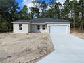 Newly constructed one-story home with a two-car garage and landscaped yard at 6809 149Th Lane Rd, Ocala, FL 34473