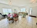 Bright dining area with a chandelier and access to the living room and kitchen at 354 Lockbreeze Dr, Davenport, FL 33897