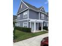 Two-story gray house with red accents and a pergola at 4563 Yellowgold Rd # 101, Kissimmee, FL 34746