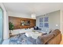 Spacious living room with a large TV and comfortable seating at 4751 Clock Tower Dr # 106, Kissimmee, FL 34746