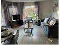 Living room with gray sofa and wood-look floors at 6402 Parc Corniche Dr # 5208, Orlando, FL 32821