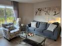 Cozy living room featuring a sofa, armchair, and coffee table, perfect for relaxing at 6402 Parc Corniche Dr # 5208, Orlando, FL 32821
