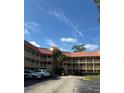 Two-story building with a tiled roof at 6402 Parc Corniche Dr # 5208, Orlando, FL 32821