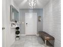 Bright entryway with a bench, mirror, and decor at 4743 Magnetite Loop, Mount Dora, FL 32757
