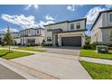 Two-story modern home with gray garage door and stone accents at 5773 High Seas Dr, Orlando, FL 32821
