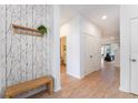 Bright and airy entryway with bench and coat rack at 4683 Terrasonesta Dr, Davenport, FL 33837