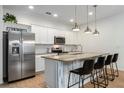 Modern kitchen with island and stainless steel appliances at 4683 Terrasonesta Dr, Davenport, FL 33837
