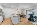 Open concept kitchen with island and stainless steel appliances at 4683 Terrasonesta Dr, Davenport, FL 33837