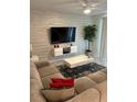Spacious living room with comfortable sectional sofa and large flat-screen TV at 3120 Paradox Cir # 102, Kissimmee, FL 34746