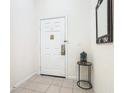 Condo entryway with white door and small side table at 3050 Pirates Retreat Ct # 108, Kissimmee, FL 34747