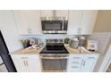 Stainless steel appliances and white shaker cabinets at 4227 Sawtooth Ct, Tavares, FL 32778