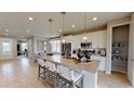 Open kitchen with island, stainless steel appliances, and breakfast bar at 4227 Sawtooth Ct, Tavares, FL 32778