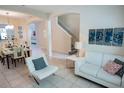 Living room features white couches and a view into dining area at 2505 Dharma Cir, Kissimmee, FL 34746